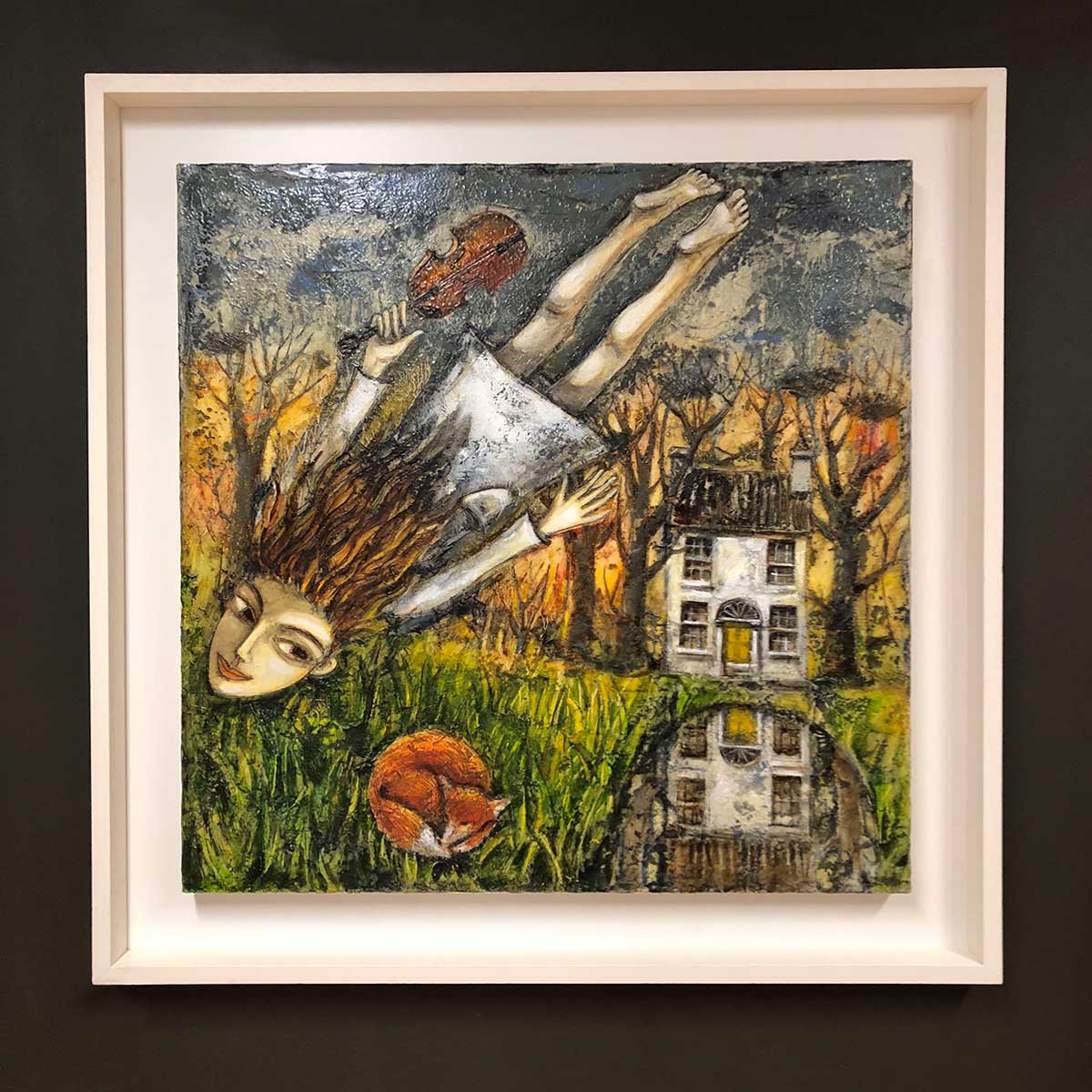 Girl holding a violin flying as in a dream over a landscape with a country house and a lake. Sun is almost rising and a fox is curled up asleep. Original painting in oil on canvas by Irish Ukrainian artist living in Inchicore, Dublin, Ireland. In a white wooden frame.