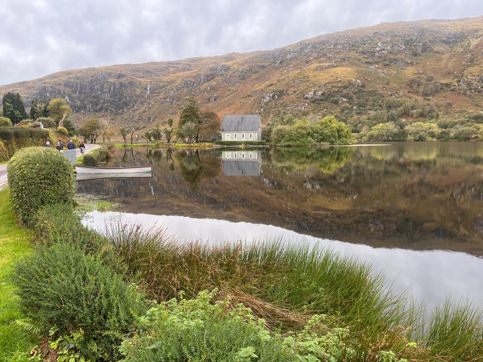 St Finbarr's Oratory and autumn hills reflected in the lake at Gougane Barra