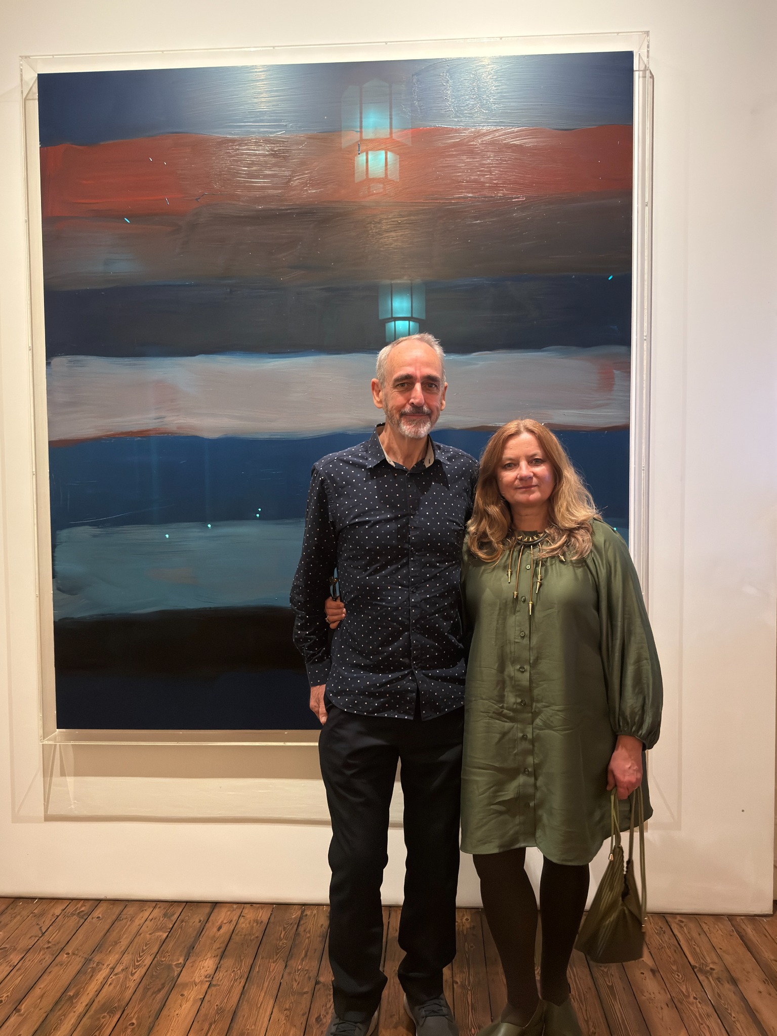 Paul and Ludmila standing in front of a large painting at the Park Hotel